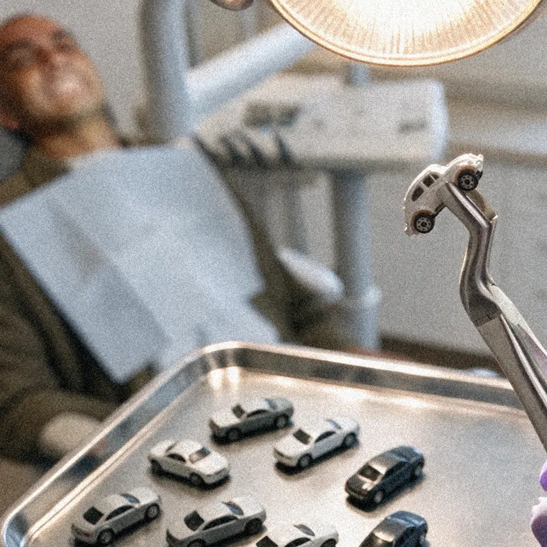 A dentist’s overhead lamp above an open mouth